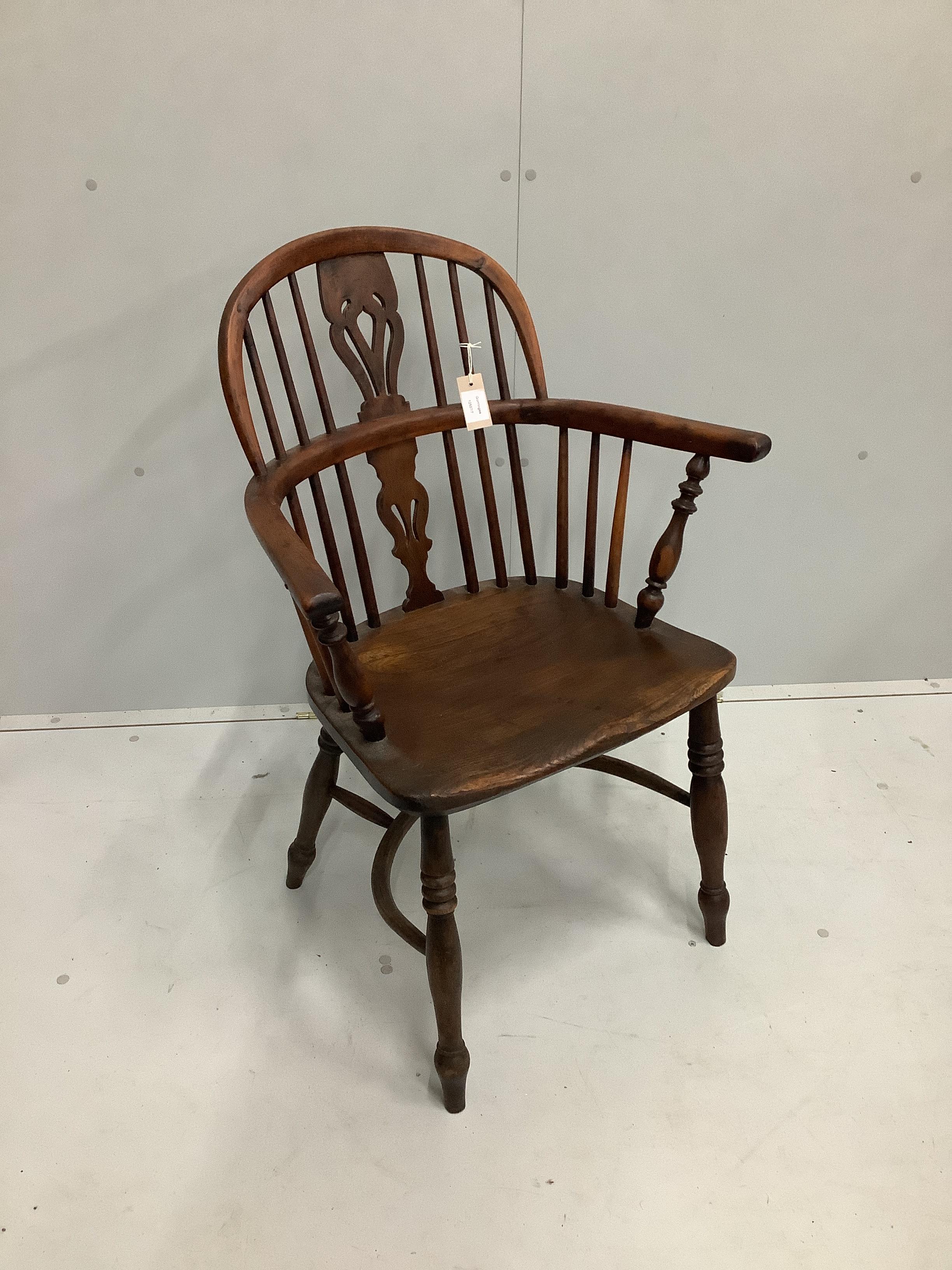 A 19th century yew, elm and beech Windsor elbow chair with crinoline stretcher, width 64cm, depth 40cm, height 92cm